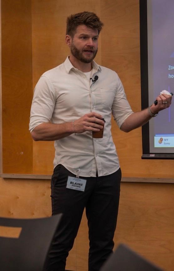 Blaine Fisher presenting at the front of a classroom